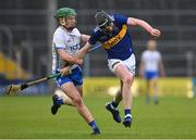 3 May 2022; Joe Egan of Tipperary is tackled by Darragh Walsh of Waterford during the Electric Ireland Munster GAA Minor Hurling Championship Semi-Final match between Tipperary and Waterford at FBD Semple Stadium in Thurles, Tipperary. Photo by Brendan Moran/Sportsfile