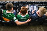 7 May 2022; Young Kerry supporters read the match programme before the Munster GAA Football Senior Championship Semi-Final match between Cork and Kerry at Páirc Ui Rinn in Cork. Photo by Stephen McCarthy/Sportsfile
