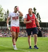 7 May 2022; Cork goalkeeper Micheál Aodh Martin leaves the pitch with Dr Aidan Kelleher, team doctor, during the Munster GAA Football Senior Championship Semi-Final match between Cork and Kerry at Páirc Ui Rinn in Cork. Photo by Stephen McCarthy/Sportsfile
