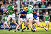 8 May 2022; Darragh O'Donovan of Limerick is stopped by Conor Stakelum, left, and Ger Browne of Tipperary during the Munster GAA Hurling Senior Championship Round 3 match between Limerick and Tipperary at TUS Gaelic Grounds in Limerick. Photo by Stephen McCarthy/Sportsfile