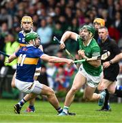 8 May 2022; Sean Finn of Limerick is tackled by Noel McGrath of Tipperary during the Munster GAA Hurling Senior Championship Round 3 match between Limerick and Tipperary at TUS Gaelic Grounds in Limerick. Photo by Ray McManus/Sportsfile