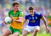 8 May 2022; Peader Mogan of Donegal in action against Cormac O'Reilly of Cavan during the Ulster GAA Football Senior Championship Semi-Final match between Cavan and Donegal at St Tiernach's Park in Clones, Monaghan. Photo by Piaras Ó Mídheach/Sportsfile
