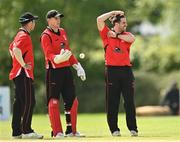 10 May 2022; Tyrone Kane of Munster Reds, right, along with team-mates Curtis Campher, left, and Munster Reds wicket keeper PJ Moor, react to a rejected appeal during the Cricket Ireland Inter-Provincial Cup match between Leinster Lightning and Munster Reds at Pembroke Cricket Club in Dublin. Photo by Sam Barnes/Sportsfile