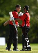10 May 2022;  PJ Moor of Munster Reds, left, celebrates with team-mate Curtis Campher after bringing up his century during the Cricket Ireland Inter-Provincial Cup match between Leinster Lightning and Munster Reds at Pembroke Cricket Club in Dublin. Photo by Sam Barnes/Sportsfile