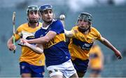11 May 2022; Ciarán Foley of Tipperary in action against Clare players James Hegarty, left, and Riain NcNamara during the Electric Ireland Munster GAA Minor Hurling Championship Final match between Tipperary and Clare at TUS Gaelic Grounds in Limerick. Photo by Piaras Ó Mídheach/Sportsfile