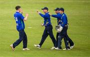 12 May 2022; William Porterfield is congratulated by North West Warriors team-mates, including bowler Conor Olphert, left, after dismissing Jeremy Lawlor of Northern Knights during the Cricket Ireland Inter-Provincial Cup match between North West Warriors and Northern Knights at Bready Cricket Club in Magheramason, Tyrone. Photo by Stephen McCarthy/Sportsfile