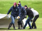 12 May 2022; Bready Cricket Club groundstaff pull the rain covers off before the Cricket Ireland Inter-Provincial Cup match between North West Warriors and Northern Knights at Bready Cricket Club in Magheramason, Tyrone. Photo by Stephen McCarthy/Sportsfile