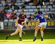 14 May 2022; Joseph Cooney of Galway passess the sliotar under pressure from Sean Downey of Laois  during the Leinster GAA Hurling Senior Championship Round 4 match between Laois and Galway at MW Hire O’Moore Park in Portlaoise, Laois. Photo by Ray McManus/Sportsfile