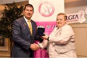 14 May 2022; Julie Fitzpatrick of Naomh Mairtin GAA club in Louth is presented with her graduation medallion by Uachtarán Cumann Peil Gael na mBan, Mícheál Naughton, during the Learn to Lead LGFA Female Leadership Programme graduation evening at the Bonnington Hotel in Dublin. The Learn to Lead programme was devised to develop the next generation of leaders within Ladies Gaelic Football. Photo by Brendan Moran/Sportsfile