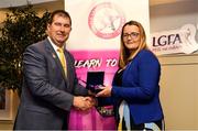 14 May 2022; Lisa Flaherty of Shamrocks GAA club in Offaly is presented with her graduation medallion by Uachtarán Cumann Peil Gael na mBan, Mícheál Naughton, during the Learn to Lead LGFA Female Leadership Programme graduation evening at the Bonnington Hotel in Dublin. The Learn to Lead programme was devised to develop the next generation of leaders within Ladies Gaelic Football. Photo by Brendan Moran/Sportsfile