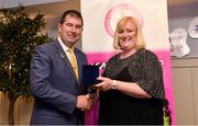 14 May 2022; Linda Walsh of Thomas Davis GAA club in Dublin is presented with her graduation medallion by Uachtarán Cumann Peil Gael na mBan, Mícheál Naughton, during the Learn to Lead LGFA Female Leadership Programme graduation evening at the Bonnington Hotel in Dublin. The Learn to Lead programme was devised to develop the next generation of leaders within Ladies Gaelic Football. Photo by Brendan Moran/Sportsfile