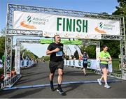 15 May 2022; Runner Stephen Kelly crosses the finish line during the Irish Runner 5k sponsored by Sports Travel International incorporating the AAI National 5k Road Championships at Phoenix Park in Dublin. Photo by Harry Murphy/Sportsfile