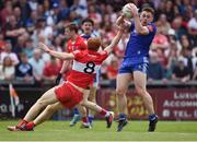 15 May 2022; Mícheál Bannigan of Monaghan in action against Conor Glass of Derry during the Ulster GAA Football Senior Championship Semi-Final match between Derry and Monaghan at Athletic Grounds in Armagh. Photo by Daire Brennan/Sportsfile