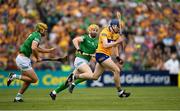 15 May 2022; David Fitzgerald of Clare in action against Séamus Flanagan and Dan Morrisey of Limerick during the Munster GAA Hurling Senior Championship Round 4 match between Clare and Limerick at Cusack Park in Ennis, Clare. Photo by Ray McManus/Sportsfile