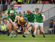15 May 2022; Shane O'Donnell of Clare is tackled by Kyle Hayes, left, and Barry Nash of Limerick during the Munster GAA Hurling Senior Championship Round 4 match between Clare and Limerick at Cusack Park in Ennis, Clare. Photo by Ray McManus/Sportsfile