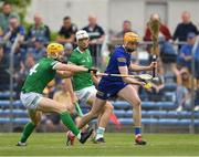 15 May 2022; Clare goalkeeper Eibhear Quilligan comes under pressure from Limerick players Séamus Flanagan and Kyle Hayes as he prepares to clear during the Munster GAA Hurling Senior Championship Round 4 match between Clare and Limerick at Cusack Park in Ennis, Clare. Photo by Ray McManus/Sportsfile