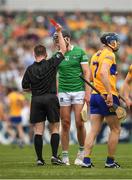 15 May 2022; Gearóid Hegarty of Limerick receives a red card, second yellow, from referee Colm Lyons during the Munster GAA Hurling Senior Championship Round 4 match between Clare and Limerick at Cusack Park in Ennis, Clare. Photo by Ray McManus/Sportsfile