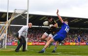 15 May 2022; Derry goalkeeper Odhran Lynch in action against Seán Jones of Monaghan during the Ulster GAA Football Senior Championship Semi-Final match between Derry and Monaghan at Athletic Grounds in Armagh. Photo by Ramsey Cardy/Sportsfile