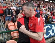 15 May 2022; Derry manager Rory Gallagher celebrates with team doctor Hugh Gallagher after the Ulster GAA Football Senior Championship Semi-Final match between Derry and Monaghan at Athletic Grounds in Armagh. Photo by Daire Brennan/Sportsfile