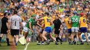 15 May 2022; Referee Colm Lyons looks on as players including David Reidy of Clare and Robbie Hanley of Limerick jostle during the Munster GAA Hurling Senior Championship Round 4 match between Clare and Limerick at Cusack Park in Ennis, Clare. Photo by Ray McManus/Sportsfile