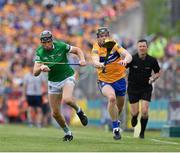 15 May 2022; Tony Kelly of Clare is tackled by Diarmaid Byrnes of Limerick during the Munster GAA Hurling Senior Championship Round 4 match between Clare and Limerick at Cusack Park in Ennis, Clare. Photo by John Sheridan/Sportsfile