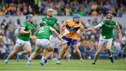 15 May 2022; Shane O'Donnell of Clare is tackled by Declan Hannon and Sean Finn of Limerick during the Munster GAA Hurling Senior Championship Round 4 match between Clare and Limerick at Cusack Park in Ennis, Clare. Photo by John Sheridan/Sportsfile