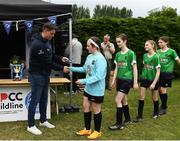 16 May 2022; Clubforce Key Account Executive Ian Morris gives a winners medal to Peamount United goalkeeper Emma Martin after the 2022 Clubforce DDSL Girls U13 League Cup Final match, the first time the DDSL has held a schoolgirls' final, between Stepaside FC and Peamount United at the AUL in Dublin. Photo by Harry Murphy/Sportsfile