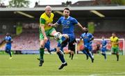 14 May 2022; Jason Sexton of Rockmount AFC in action against Colm Karney of Bluebell United during the FAI Centenary Intermediate Cup Final 2021/2022 match between Rockmount AFC and Bluebell United at Turner's Cross in Cork. Photo by Seb Daly/Sportsfile