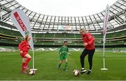 17 May 2022; The SPAR FAI Primary School 5s National Finals took place in AVIVA Stadium on Tuesday, May 17, where former Republic of Ireland International David Meyler and current Republic of Ireland women's footballer, Louise Quinn were in attendance supporting as girls and boys from 28 schools took to the field in a day that they will never forget. The 2022 SPAR FAI Primary School 5s Programme returned in physical form this year and saw an incredible 56,212 students involved from 1,081 schools. Pictured is Republic of Ireland women's footballer Louise Quinn with  Eden Murphy and Layla Mooney at the Aviva Stadium in Dublin. Photo by Harry Murphy/Sportsfile