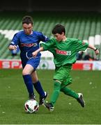 17 May 2022; The SPAR FAI Primary School 5s National Finals took place in AVIVA Stadium on Tuesday, May 17, where former Republic of Ireland International David Meyler and current Republic of Ireland women's footballer, Louise Quinn were in attendance supporting as girls and boys from 28 schools took to the field in a day that they will never forget. The 2022 SPAR FAI Primary School 5s Programme returned in physical form this year and saw an incredible 56,212 students involved from 1,081 schools. Pictured is Dylan Pedreschi of Catherine McAuley NS, Dublin, in action against Ben Sweeney of Scoil Chiaráin, Dublin, at the Aviva Stadium in Dublin. Photo by Harry Murphy/Sportsfile