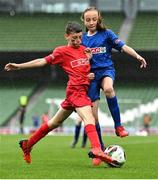 17 May 2022; The SPAR FAI Primary School 5s National Finals took place in AVIVA Stadium on Tuesday, May 17, where former Republic of Ireland International David Meyler and current Republic of Ireland women's footballer, Louise Quinn were in attendance supporting as girls and boys from 28 schools took to the field in a day that they will never forget. The 2022 SPAR FAI Primary School 5s Programme returned in physical form this year and saw an incredible 56,212 students involved from 1,081 schools. Pictured are Ryan Greenstein of Thomastown NS, Tipperary, in action against Ciara Redmond of Ballymurn NS, Wexford, at the Aviva Stadium in Dublin. Photo by Piaras Ó Mídheach/Sportsfile