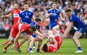 15 May 2022; Gareth McKinless of Derry under pressure from Karl O'Connell, left, and Ryan McAnespie of Monaghan during the Ulster GAA Football Senior Championship Semi-Final match between Derry and Monaghan at Athletic Grounds in Armagh. Photo by Ramsey Cardy/Sportsfile