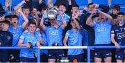 18 May 2022; Dublin's Clyde Burke lifts the cup surrounded by team-mates after the Electric Ireland Leinster GAA Minor Football Championship Final match between Dublin and Kildare at MW Hire O'Moore Park in Portlaoise, Laois. Photo by Stephen McCarthy/Sportsfile