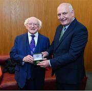 20 May 2022; FAI president Gerry McAnaney presents President of Ireland Michael D Higgins with an FAI centenary medal during the FAI Centenary Late Late Show Special at RTE Studios in Dublin. Photo by Stephen McCarthy/Sportsfile