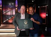 20 May 2022; John Charlton, son of the late Jack Charlton, Republic of Ireland manager, is presented with a Book of Condolence by former Republic of Ireland international Paul McGrath, right, during the FAI Centenary Late Late Show Special at RTE Studios in Dublin. Photo by Stephen McCarthy/Sportsfile