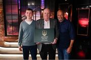 20 May 2022; John Charlton, son of the late Jack Charlton, Republic of Ireland manager, and his son John, left, are presented with a Book of Condolence by former Republic of Ireland international Paul McGrath, right, during the FAI Centenary Late Late Show Special at RTE Studios in Dublin. Photo by Stephen McCarthy/Sportsfile