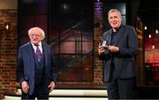 20 May 2022; President of Ireland Michael D Higgins presents former Republic of Ireland international Packie Bonner with an FAI centenary medal during the FAI Centenary Late Late Show Special at RTE Studios in Dublin. Photo by Stephen McCarthy/Sportsfile