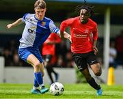 21 May 2022; King Obular of Corduff FC in action against Daniel McCarthy of College Corinthians AFC during the FAI Centenary Under 17 Cup Final 2021/2022 match between Corduff FC, Dublin, and College Corinthians AFC, Cork, at Home Farm Football Club in Dublin. Photo by Brendan Moran/Sportsfile