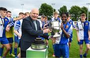 21 May 2022; FAI president Gerry McAnaney presents the cup to College Corinthians AFC captain Harvey Skieters after the FAI Centenary Under 17 Cup Final 2021/2022 match between Corduff FC, Dublin, and College Corinthians AFC, Cork, at Home Farm Football Club in Dublin. Photo by Brendan Moran/Sportsfile