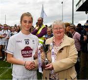 21 May 2022; The Kildare captain Katie Ray is presented with the cup by Geraldine Carey, LGFA Management, after the Ladies Football U14 All-Ireland Gold Final match between Kildare and Tipperary at Crettyard GAA in Laois. Photo by Ray McManus/Sportsfile