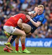 21 May 2022; Jamie Osborne of Leinster is tackled by Dan Goggin and Chris Farrell of Munster during the United Rugby Championship match between Leinster and Munster at Aviva Stadium in Dublin. Photo by Brendan Moran/Sportsfile