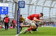 21 May 2022; Jack O'Donoghue of Munster on his way to scoring his side's first try despite the tackle of Cormac Foley of Leinster during the United Rugby Championship match between Leinster and Munster at the Aviva Stadium in Dublin. Photo by Harry Murphy/Sportsfile