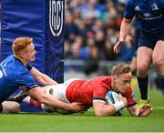 21 May 2022; Mike Haley of Munster dives over to score his side's second try despite the tackle of Ciarán Frawley of Leinster during the United Rugby Championship match between Leinster and Munster at the Aviva Stadium in Dublin. Photo by Harry Murphy/Sportsfile