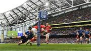 21 May 2022; Jack O'Donoghue of Munster on his way to scoring his side's first try despite the tackle of Cormac Foley of Leinster during the United Rugby Championship match between Leinster and Munster at the Aviva Stadium in Dublin. Photo by Harry Murphy/Sportsfile