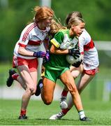 22 May 2022; Ava Kenny of Offaly is tackled by Nora Harkin, left, and Orlaíth Deehan of Derry during the 2022 All-Ireland U14 Bronze Final between Derry and Offaly at the GAA National Games Development Centre in Abbotstown, Dublin. Photo by Ben McShane/Sportsfile