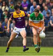 22 May 2022; Cian Donohoe of Offaly in action against Paidí Hughes of Wexford during the Tailteann Cup Preliminary Round match between Wexford and Offaly at Bellefield in Enniscorthy, Wexford. Photo by Brendan Moran/Sportsfile