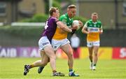 22 May 2022; Declan Hogan of Offaly is tackled by Michael Furlong of Wexford during the Tailteann Cup Preliminary Round match between Wexford and Offaly at Bellefield in Enniscorthy, Wexford. Photo by Brendan Moran/Sportsfile