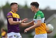 22 May 2022; Eoin Porter of Wexford, left, reacts after fouling Niall McNamee of Offaly and giving away a free kick during the Tailteann Cup Preliminary Round match between Wexford and Offaly at Bellefield in Enniscorthy, Wexford. Photo by Brendan Moran/Sportsfile