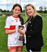 22 May 2022; Derry captain Brannagh Brolly is presented the cup from Leinster LGFA President and LGFA Vice-president Trina Murray after the 2022 All-Ireland U14 Bronze Final between Derry and Offaly at the GAA National Games Development Centre in Abbotstown, Dublin. Photo by Ben McShane/Sportsfile