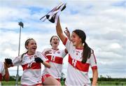 22 May 2022; Derry captain Brannagh Brolly lifts the cup as teammates Áine Young, left, and Áine Young approach to celebrate after the 2022 All-Ireland U14 Bronze Final between Derry and Offaly at the GAA National Games Development Centre in Abbotstown, Dublin. Photo by Ben McShane/Sportsfile
